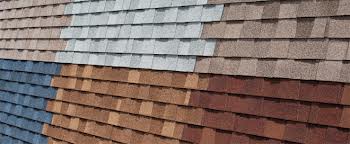 a selection of new roof shingles are laid side by side on the floor